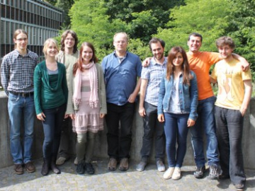 Summer meeting of the Leibniz Graduate School: 7 students and a professor standing together